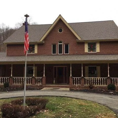 Craftsman-style home with new roofing and a wrap-around front porch
