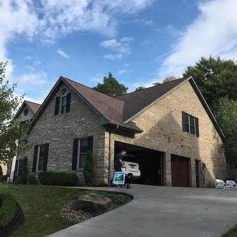 Stone-and-siding home with attached garage and a freshly installed roof