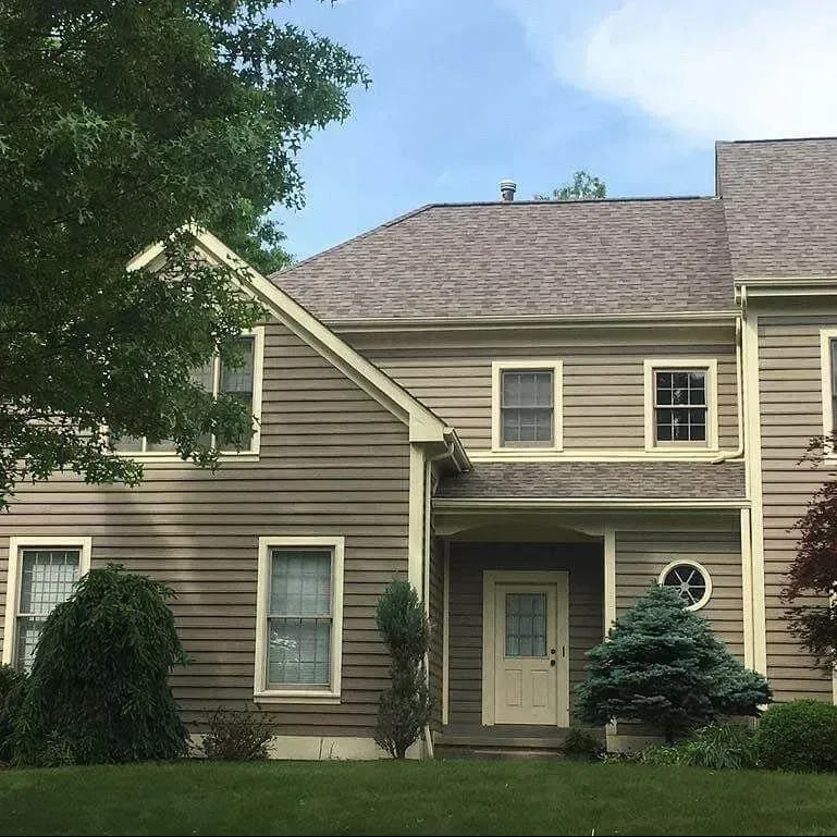 Brick home with manicured lawn and a completed exterior renovation