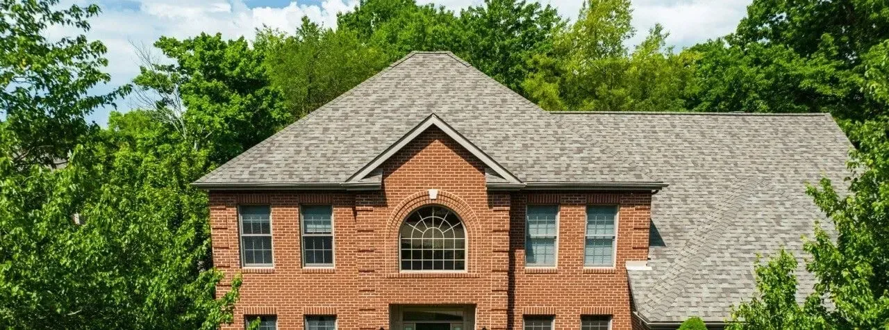 Brick home with a tan roof completed by Ireland Contracting