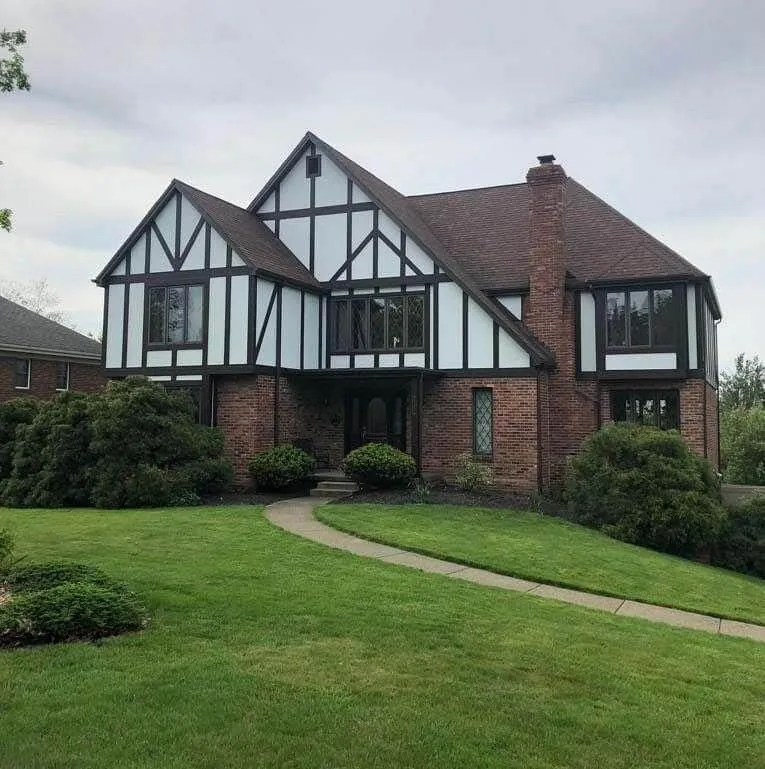 Tudor-style home with dark accents and a new roof