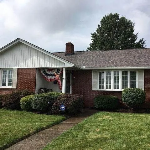 Brick ranch home with a new roof and walkway
